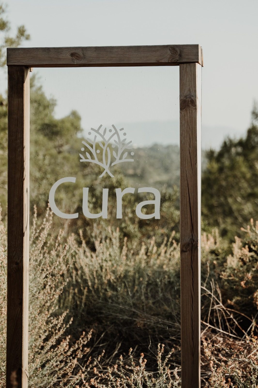 The etched glass Cura sign overlooking the valley