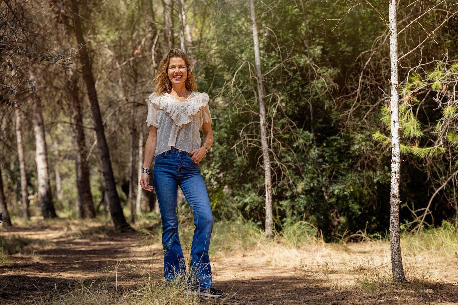Suzan Grootscholten, coach and mindfulness trainer, on a forest path near Cura